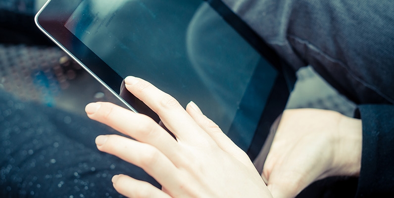 Hoopla Closeup of hands holding a tablet