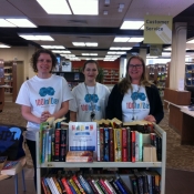 three HPL staff wearing 100In1Day shirts in the library