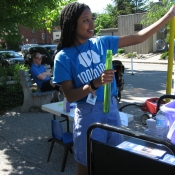 HPL staff member making bubbles outside during 100In1Day event