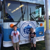 Two kids leaning against the front of the Bookmobile in Bayfront park